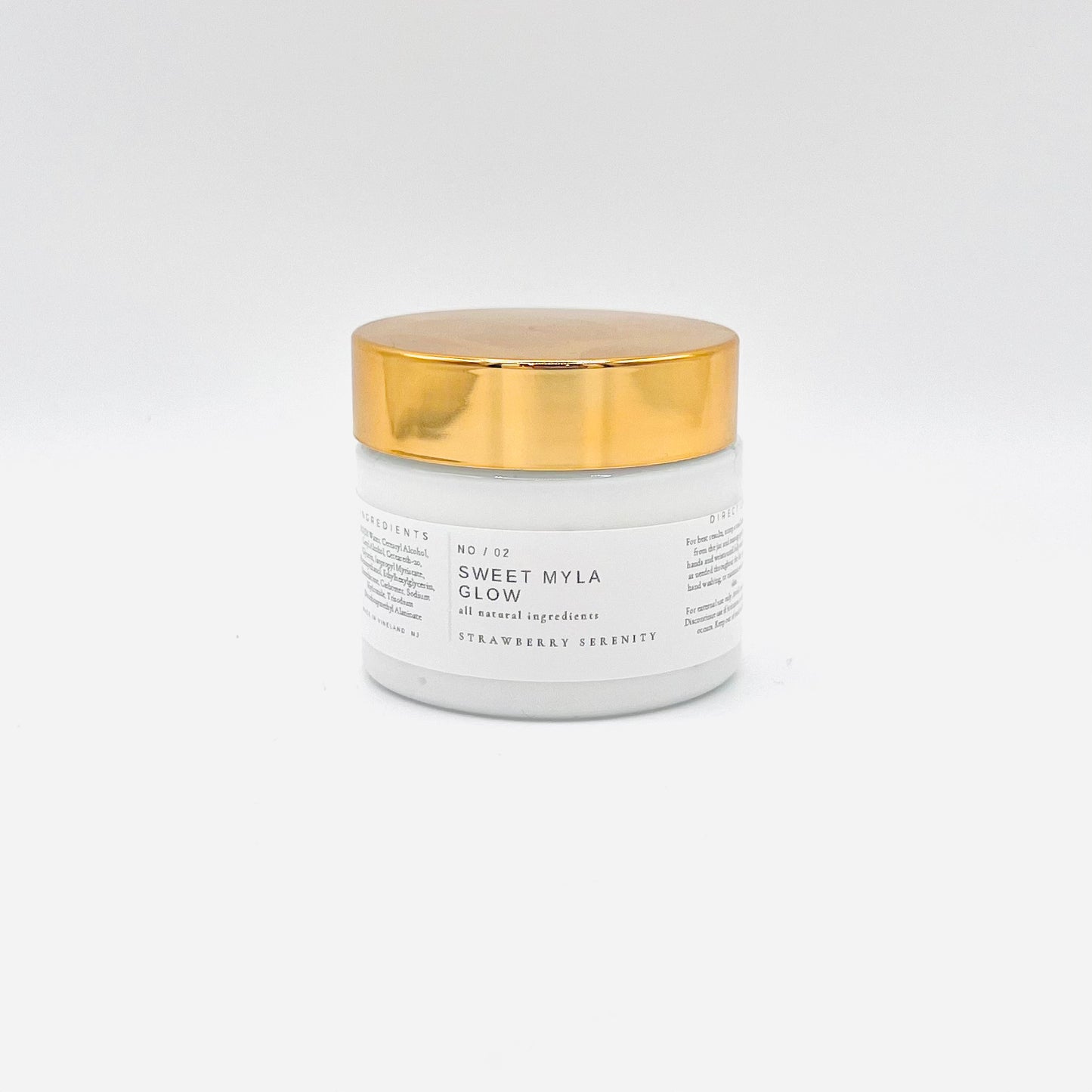 A jar with a label that says Sweet Myla Glow Strawberry Serenity Hand Lotion