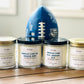 Four candles with white label that start with Smells like…