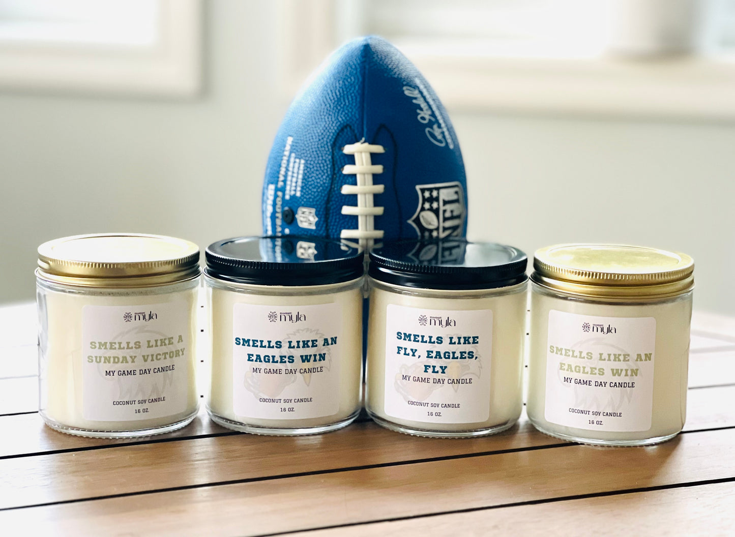 Four candles with white label that start with Smells like…