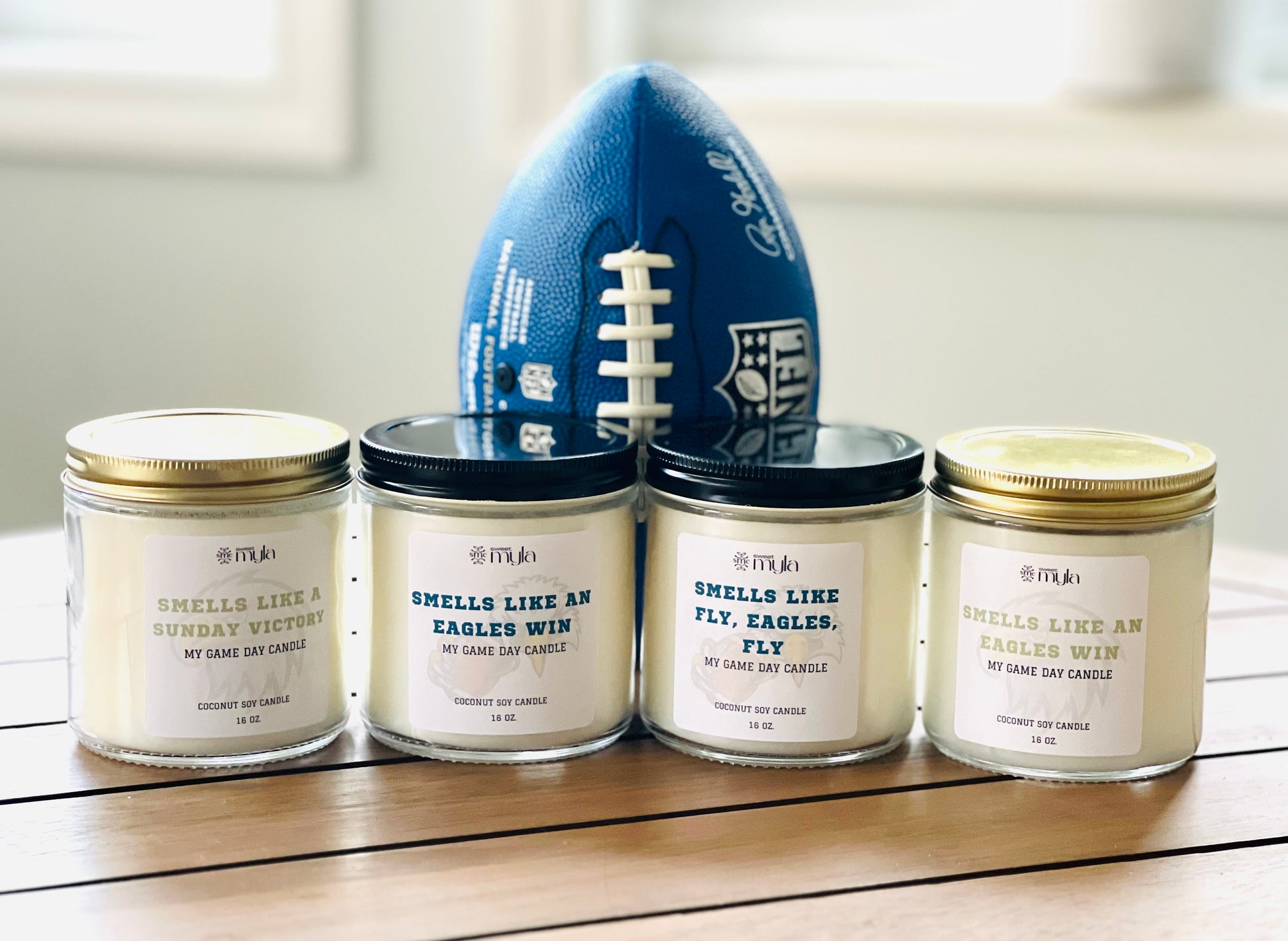 Four candles with white label that start with Smells like…