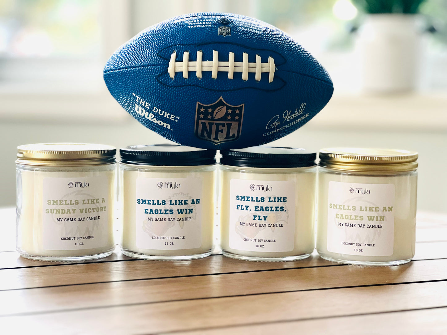 Four candles with white label that start with Smells like…