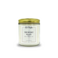 Candle with a gold lid with scents of aquatic, grapefruit, magnolia, musk and 'The Secret Place' label on a white background