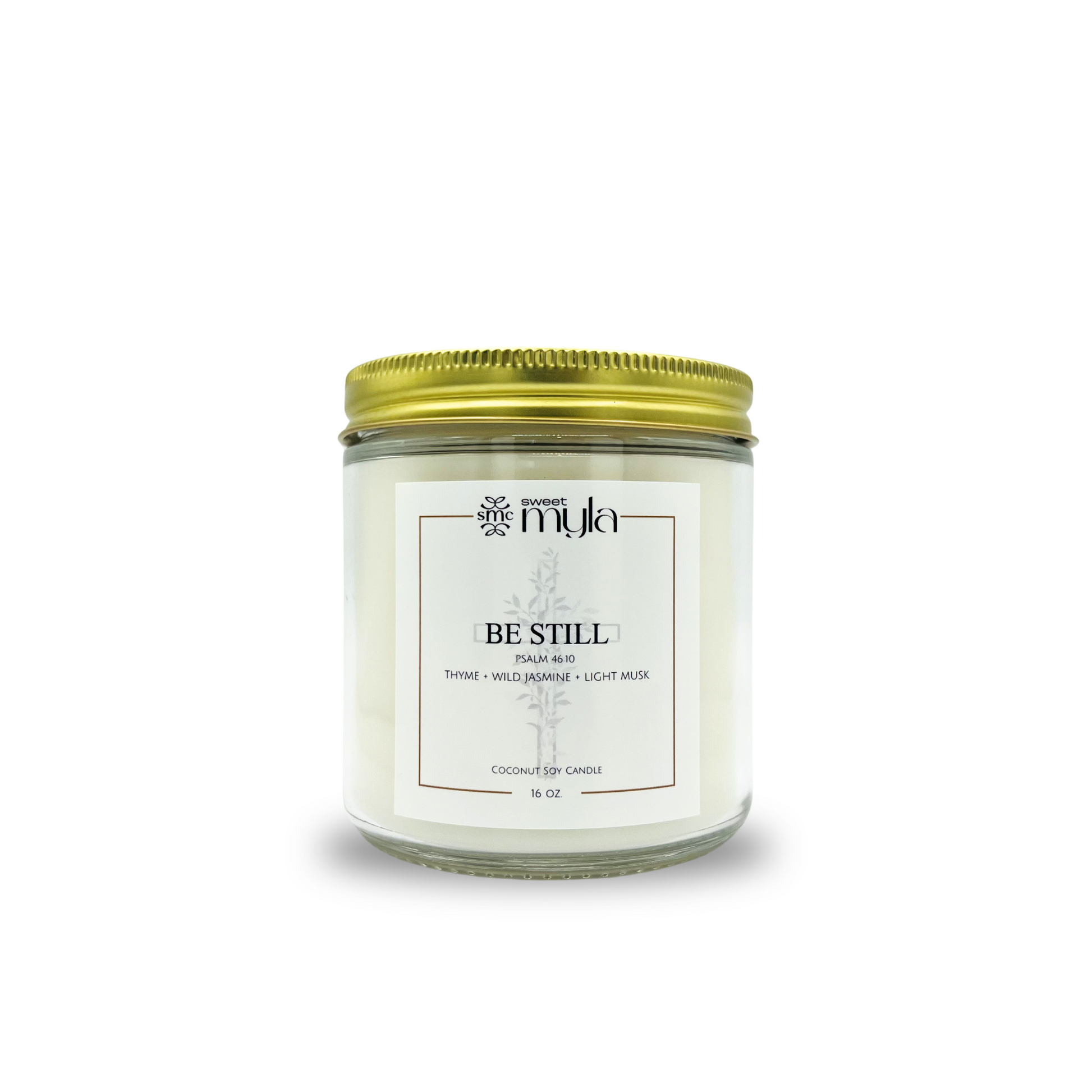Candle jar with a gold lid labeled 'Be Still' on a white background