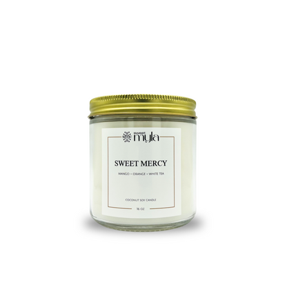 Candle jar labeled 'Sweet Mercy' with a gold lid on a white background