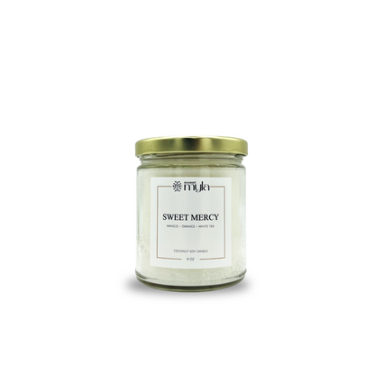 Candle jar labeled 'Sweet Mercy' with a gold lid on a white background