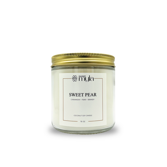 Candle jar labeled 'Sweet Pear' with a gold lid on a white background