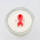 Candle in a glass jar with a pink cancer  ribbon on a white background