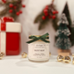 Candle labeled 'Silent Night' with festive background including a gift and small tree.