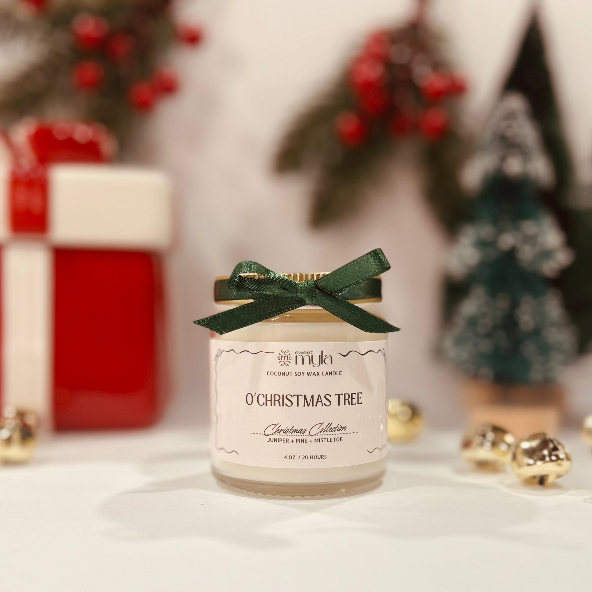 Candle jar labeled 'O'Christmas Tree' with decorative bow, Christmas-themed background.