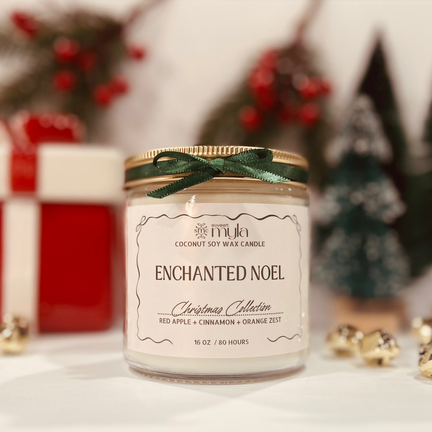 Candle labeled 'Enchanted Noel' with festive background