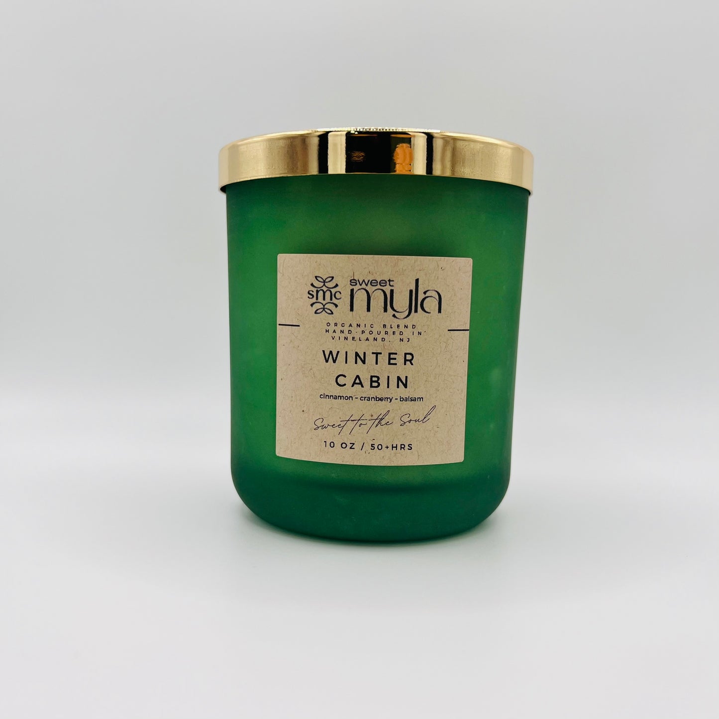 A candle with a label that says Winter Cabin