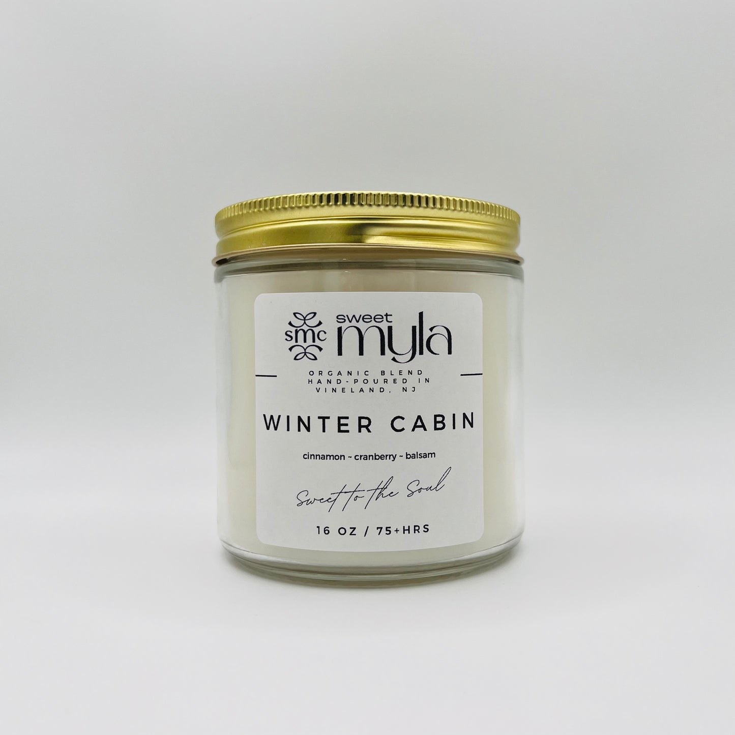 A candle with a label that says Winter Cabin