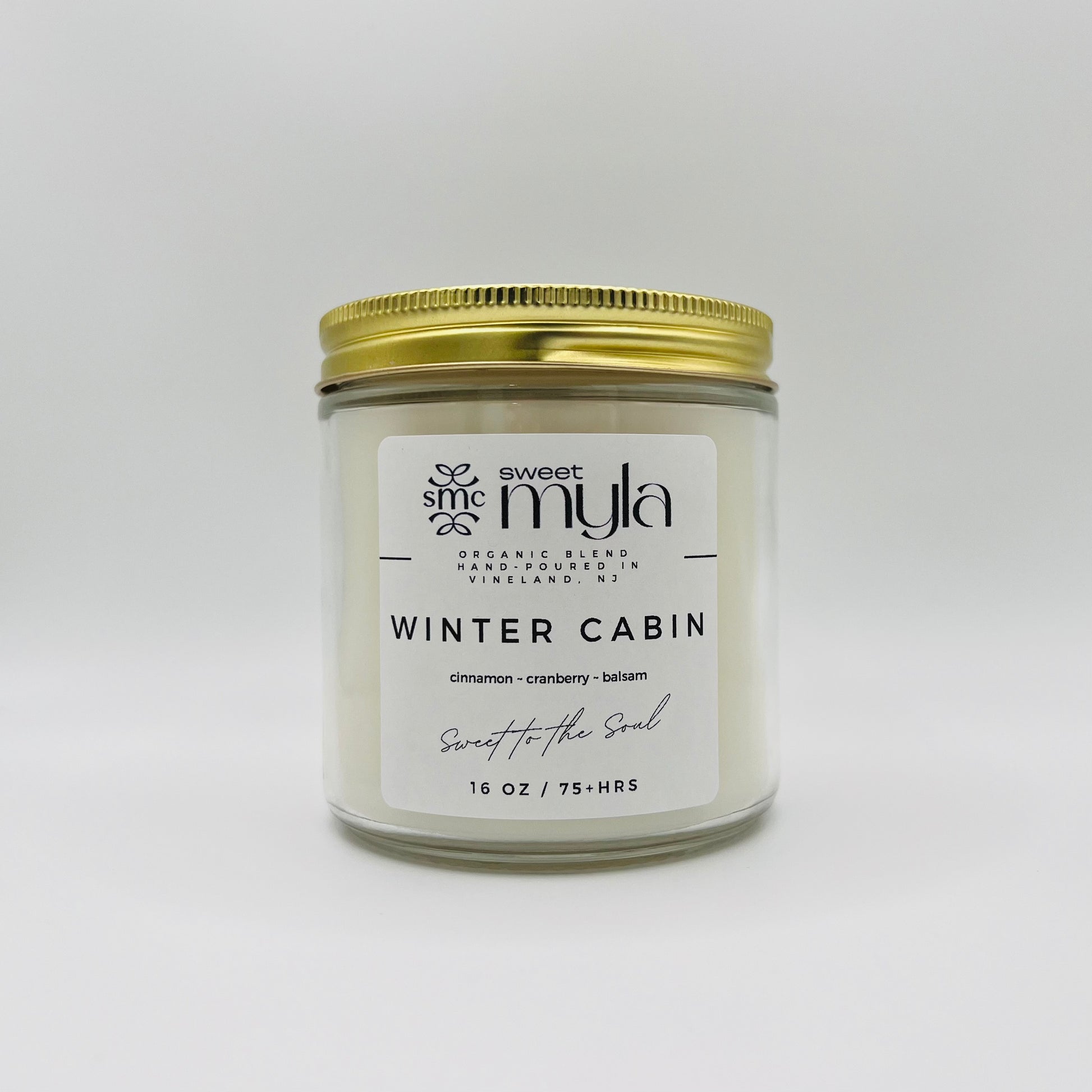 A candle with a label that says Winter Cabin