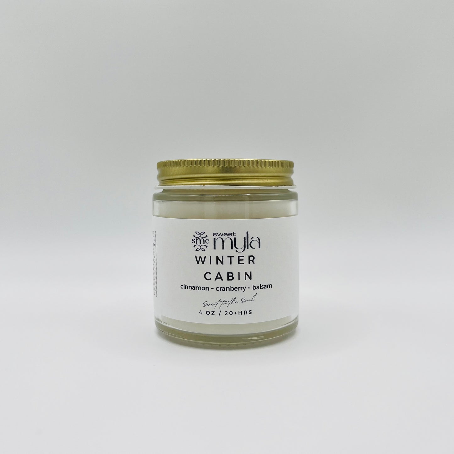 A candle with a label that says Winter Cabin