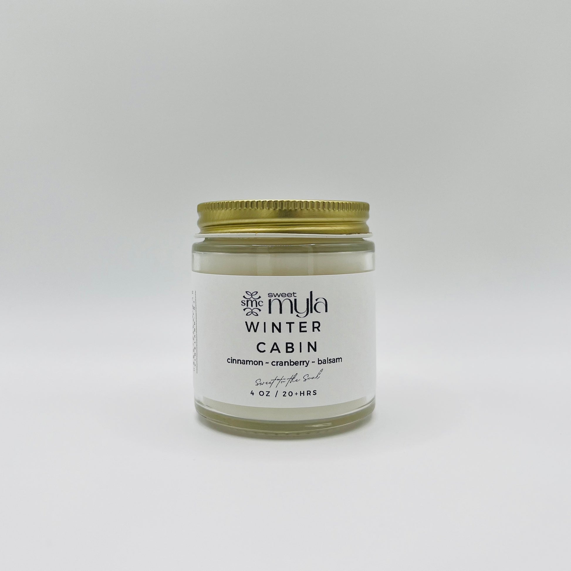 A candle with a label that says Winter Cabin