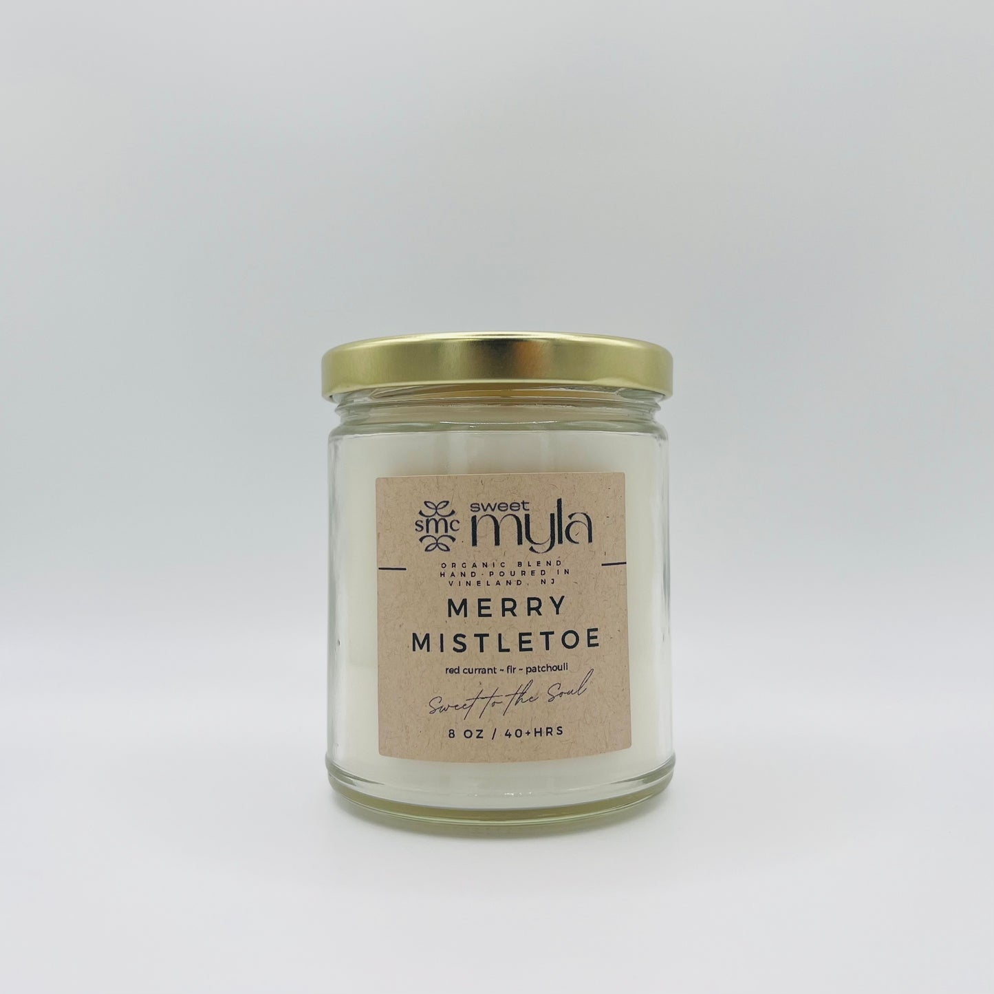 A candle with a label that says Merry Mistletoe