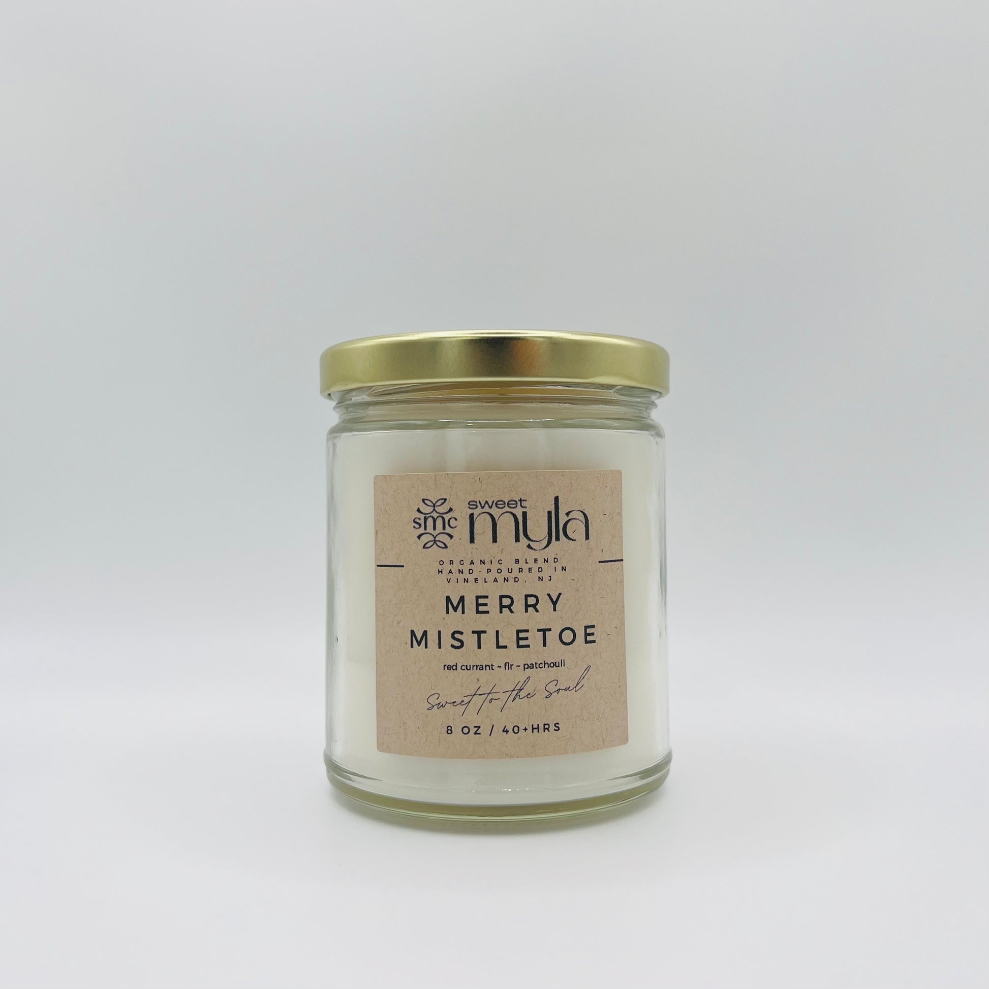 A candle with a label that says Merry Mistletoe