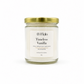A 16 oz coconut soy candle in a clear glass jar with a white label reading 'Timeless Vanilla' by the brand 'Sweet Myla', topped with a metallic gold screw-on lid, set against a plain white background.
