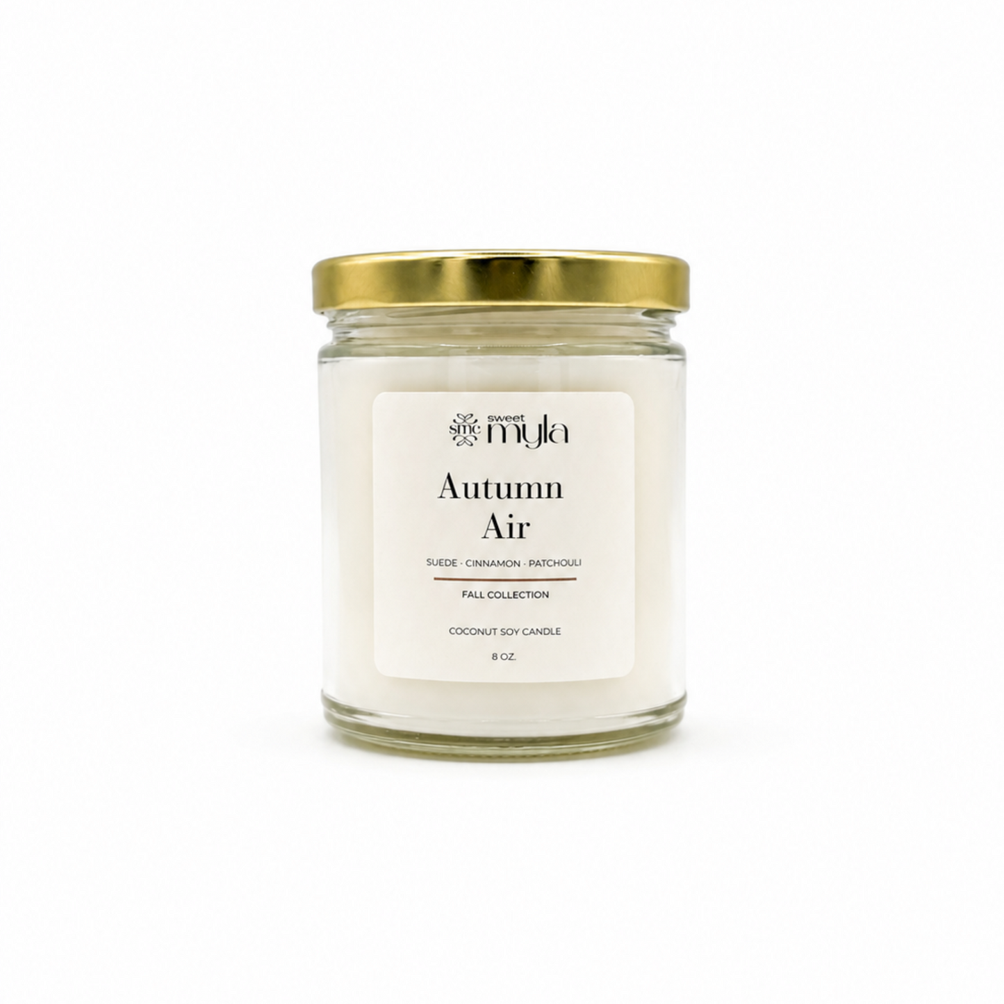 A 8 oz coconut soy candle in a clear glass jar with a white label reading 'Autumn Air' and a gold metal lid, set against a plain white background.