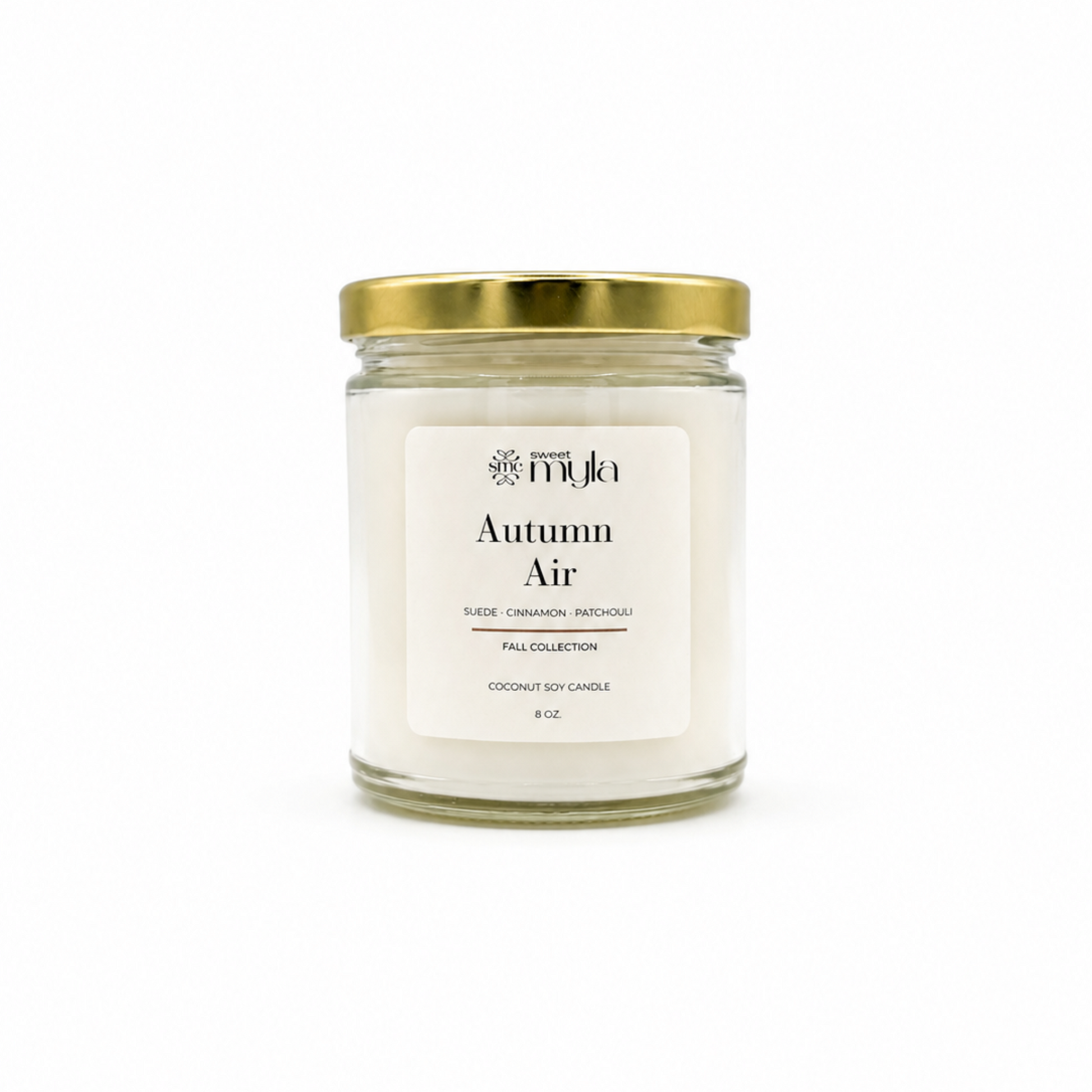A 8 oz coconut soy candle in a clear glass jar with a white label reading 'Autumn Air' and a gold metal lid, set against a plain white background.