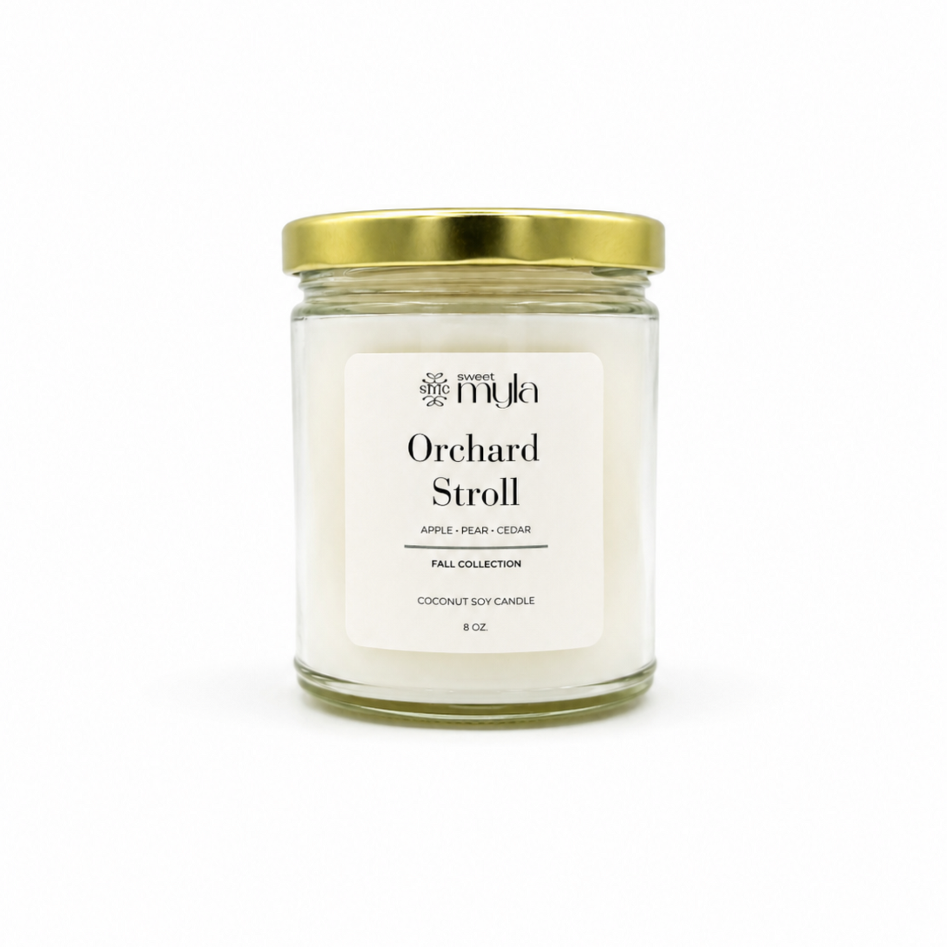 A 8oz soy candle in a clear glass jar with a white label and a gold metal lid, labeled 'Orchard Stroll' by the brand Sweet Myla