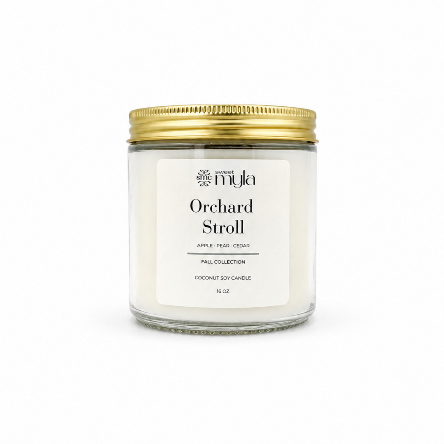 A 16 oz soy candle in a clear glass jar with a white label and a gold metal lid, labeled 'Orchard Stroll' by the brand Sweet Myla
