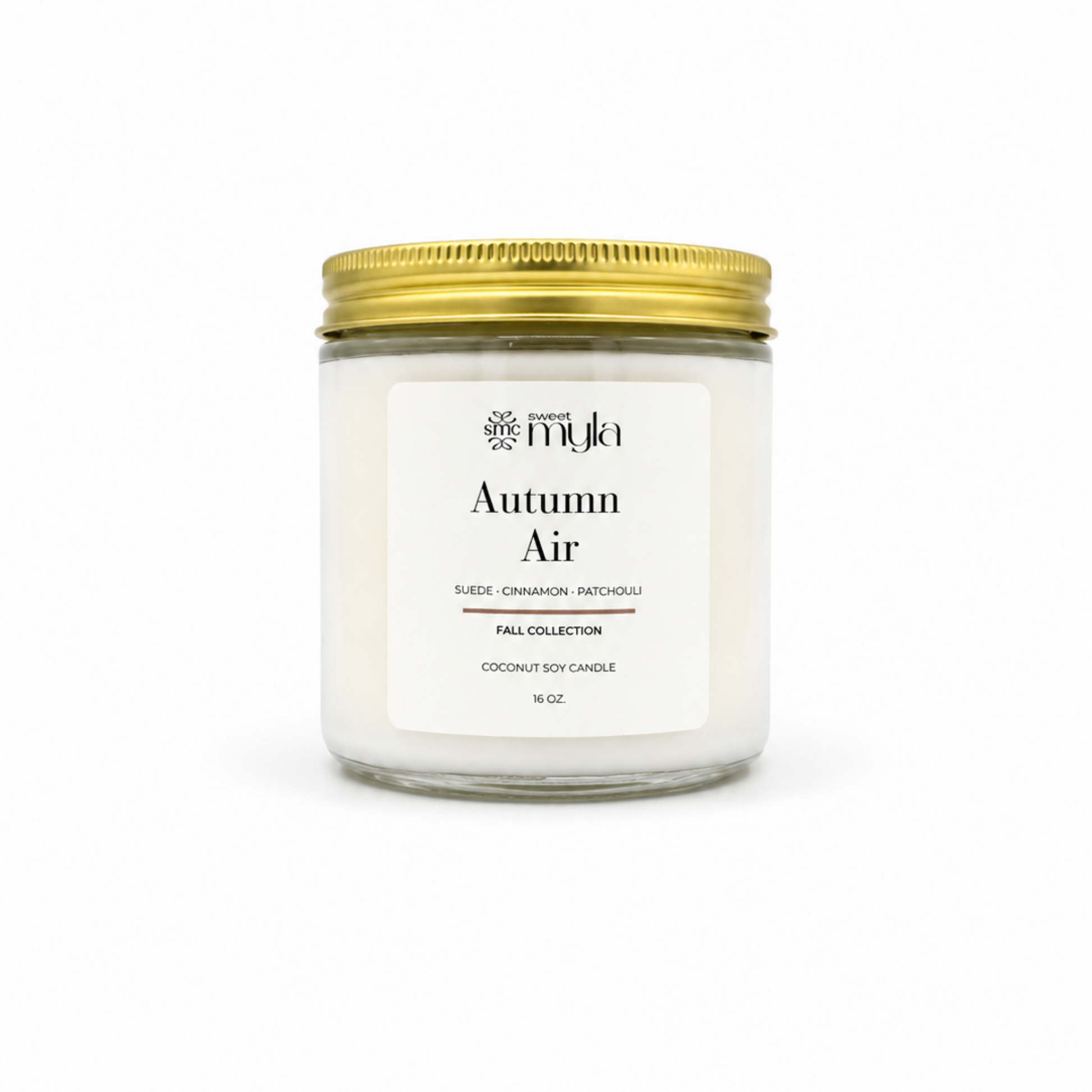 A 16 oz coconut soy candle in a clear glass jar with a white label reading 'Autumn Air' by the brand 'Sweet Myla', topped with a metallic gold screw-on lid, set against a plain white background.