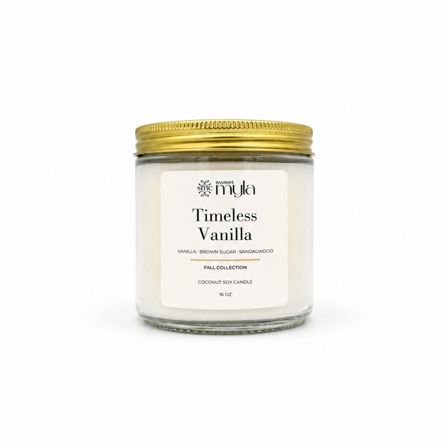 A 8 oz coconut soy candle in a clear glass jar with a white label reading 'Timeless Vanilla' by the brand 'Sweet Myla', topped with a metallic gold screw-on lid, set against a plain white background.
