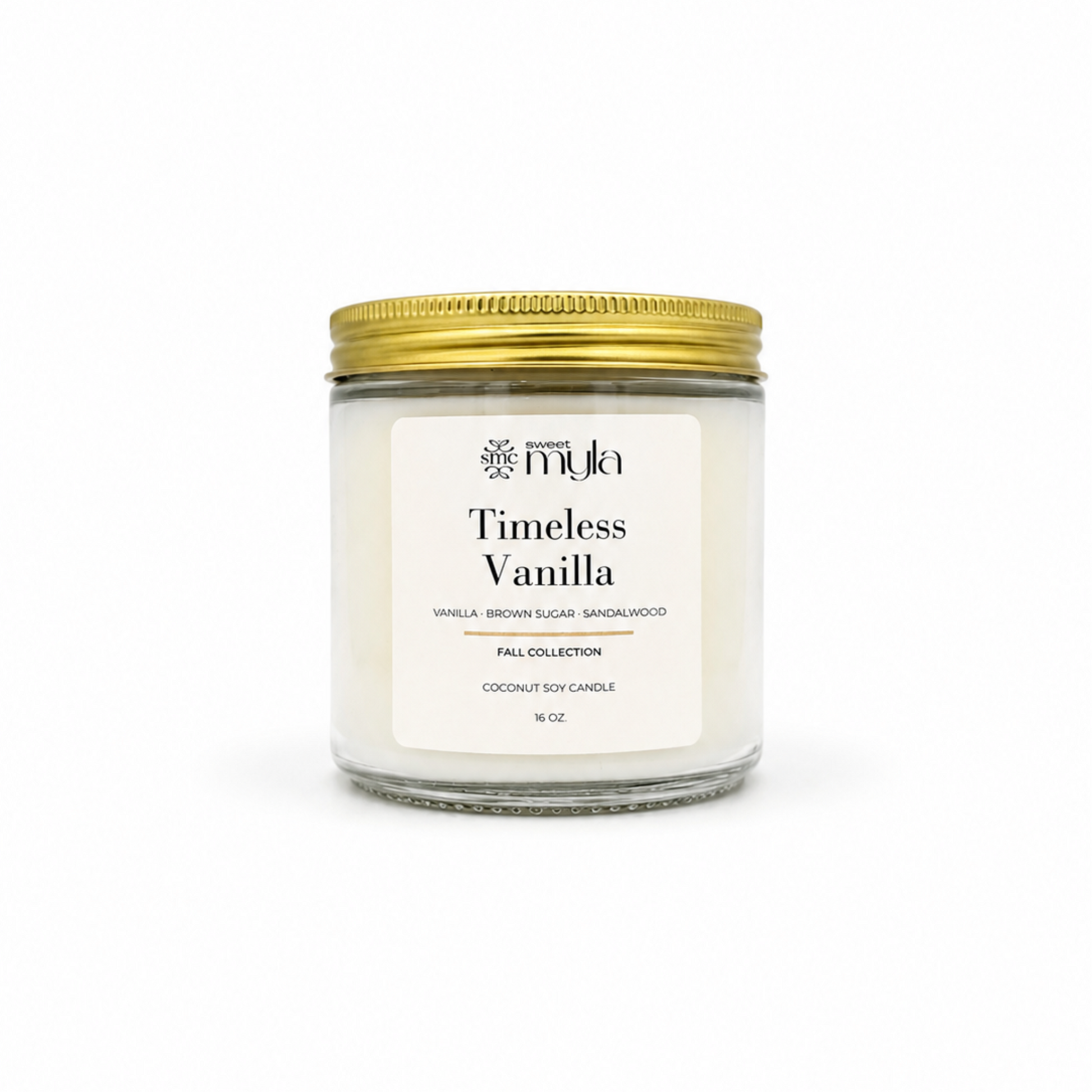 A 8 oz coconut soy candle in a clear glass jar with a white label reading 'Timeless Vanilla' by the brand 'Sweet Myla', topped with a metallic gold screw-on lid, set against a plain white background.