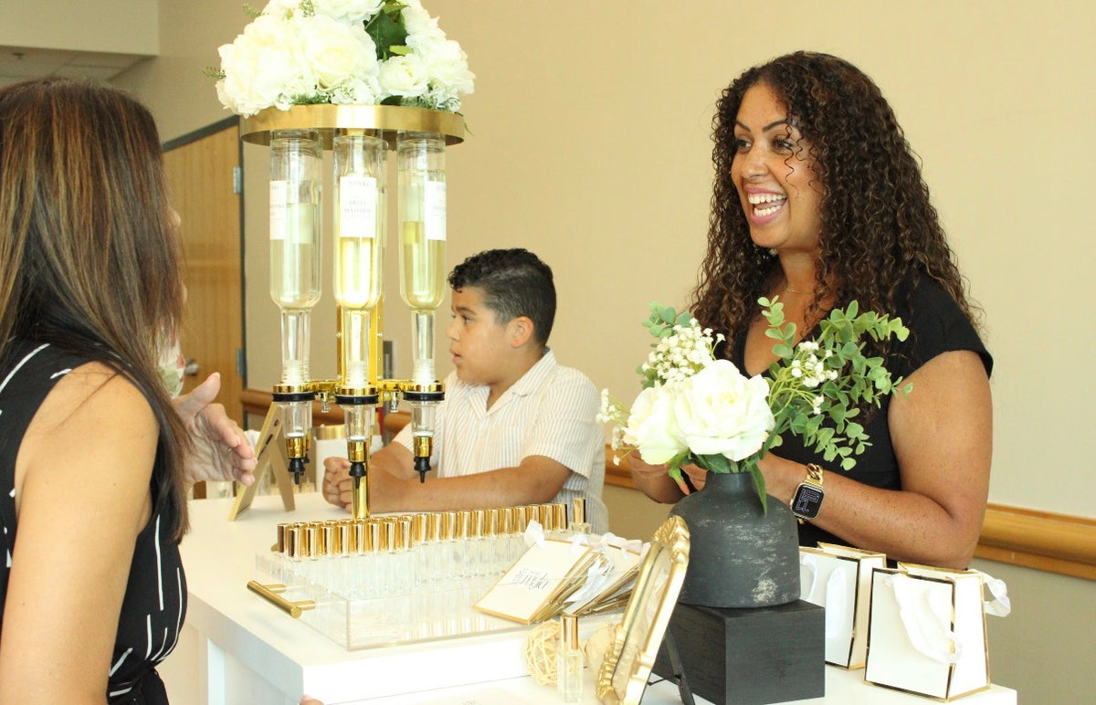 Load video: Guests enjoying the Sweet Myla interactive fragrance bar at a private event.